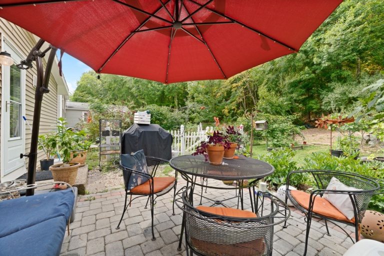 NetPro Agency llc Patio with red umbrella real estate photo by NetPro Agency