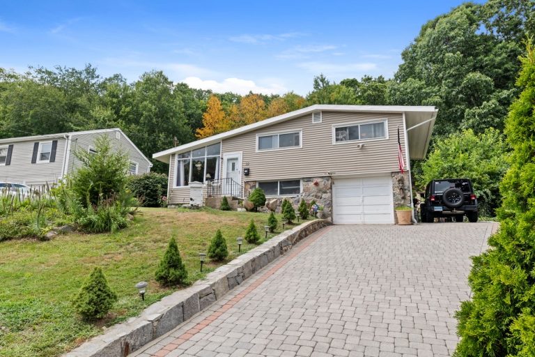 NetPro Agency llc Home exterior with driveway and trees by NetPro Agency