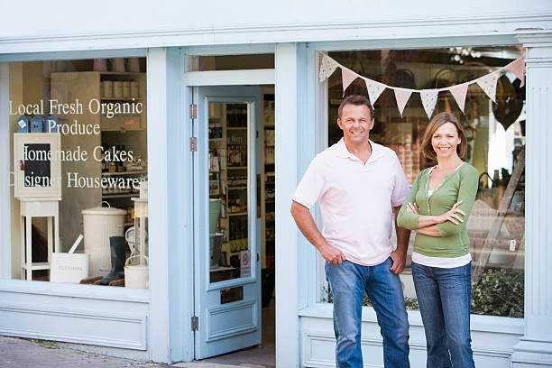 a man and woman standing in front of a store
